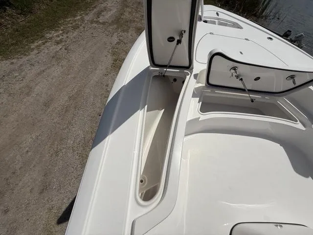 Slide: The Image of 2024 Tidewater 2410 Bay Max boat with open storage compartments on deck. - 39