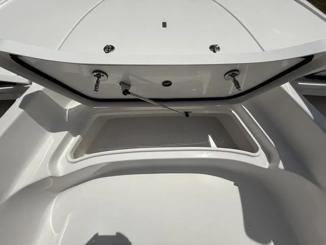 Slide: The Image of 2024 Tidewater 2410 Bay Max boat storage compartment, open and empty, showcasing interior space. - 40