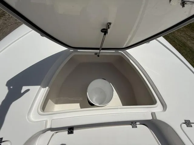 Slide: The Image of 2024 Tidewater 2410 Bay Max storage compartment with open lid and bucket inside. - 42