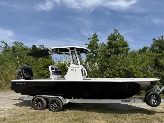 Slide: The Image of 2024 Tidewater 2410 Bay Max boat on trailer, black hull, parked outdoors. - 44