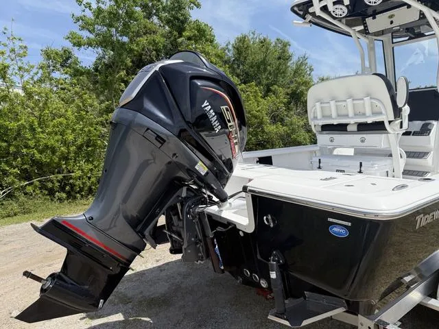 Slide: The Image of 2024 Tidewater 2410 Bay Max boat with Yamaha outboard motor, parked outdoors. - 5