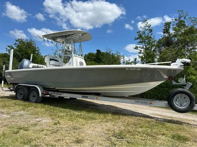 Slide: The Image of 2021 Pathfinder 2600 HPS boat on trailer, parked outdoors under a blue sky. - 2