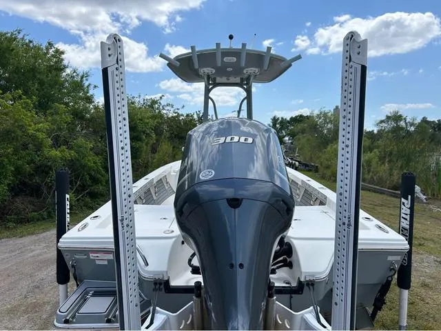 Slide: The Image of 2021 Pathfinder 2600 HPS boat with powerful engine, parked outdoors under blue sky. - 5