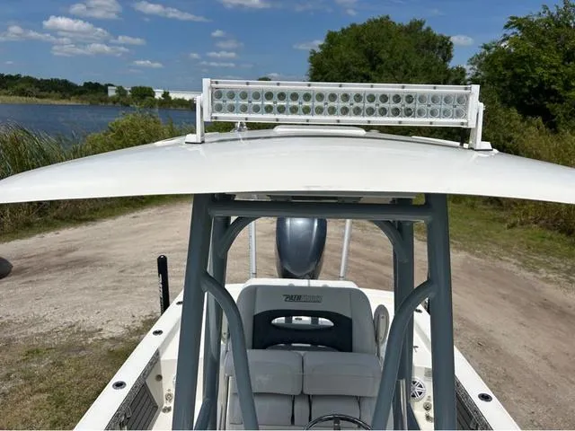 Slide: The Image of 2021 Pathfinder 2600 HPS boat with LED light bar, parked near a lake under a clear sky. - 9