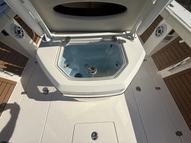 Slide: The Image of 2023 Pathfinder 2700 Open boat deck with open storage compartment and speakers. - 10