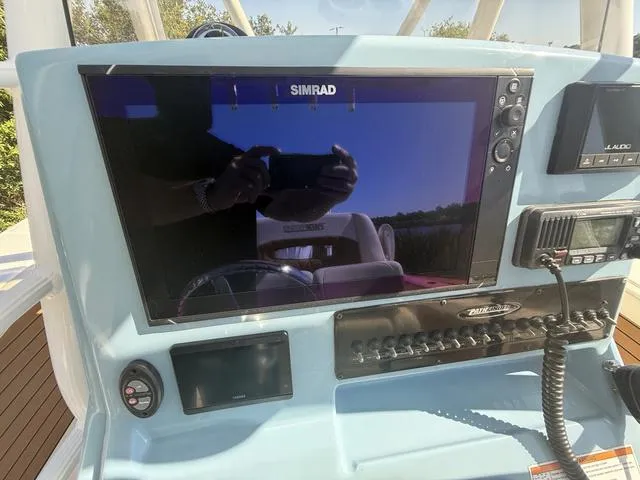 Slide: The Image of Control panel of 2023 Pathfinder 2700 Open boat with Simrad display and communication equipment. - 12