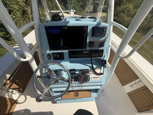 Slide: The Image of 2023 Pathfinder 2700 Open boat console with steering wheel and navigation equipment. - 14
