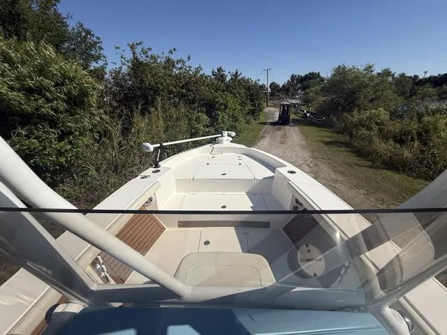 Slide: The Image of 2023 Pathfinder 2700 Open boat on a dirt path surrounded by greenery. - 15