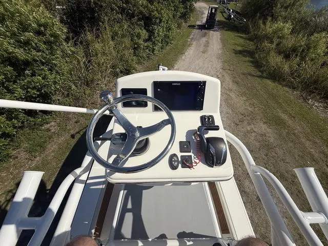 Slide: The Image of 2023 Pathfinder 2700 Open boat helm with steering wheel and controls, on a dirt path. - 18