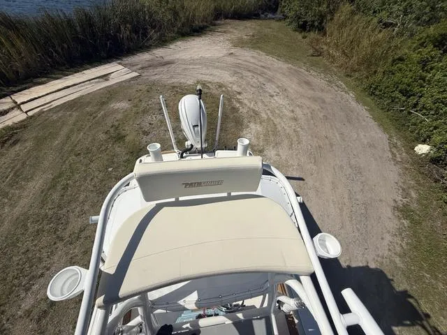 Slide: The Image of 2023 Pathfinder 2700 Open boat on a dirt path near water and greenery. - 19