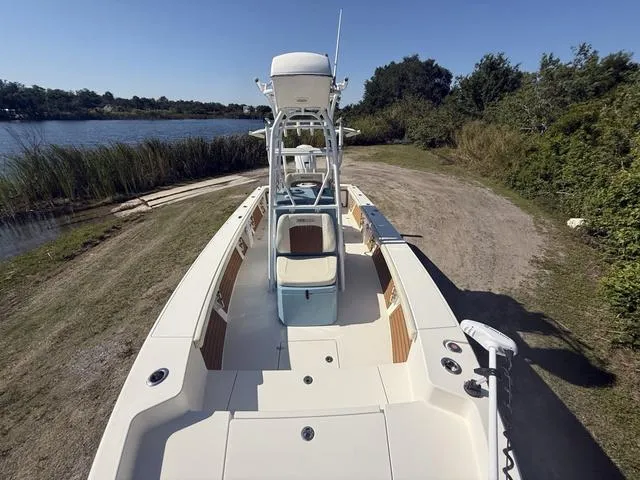 Slide: The Image of 2023 Pathfinder 2700 Open boat on a grassy shore near a lake. - 21