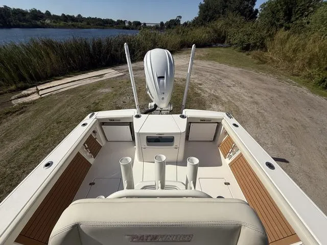 Slide: The Image of 2023 Pathfinder 2700 Open boat at a lakeside launch area, featuring a spacious deck. - 26