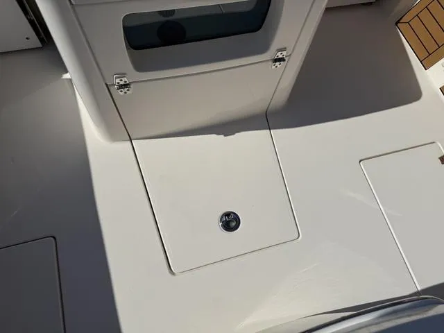 Slide: The Image of 2023 Pathfinder 2700 Open boat deck with storage compartments and sleek design. - 30