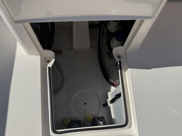 Slide: The Image of 2023 Pathfinder 2700 Open boat storage compartment with visible hoses and equipment. - 31