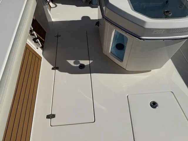 Slide: The Image of 2023 Pathfinder 2700 Open boat deck with storage compartments and seating area. - 34