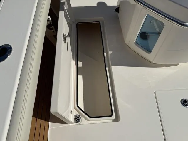 Slide: The Image of 2023 Pathfinder 2700 Open boat deck with storage compartment open. - 35