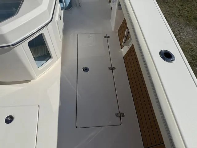 Slide: The Image of 2023 Pathfinder 2700 Open boat deck with storage compartments and sleek design. - 36