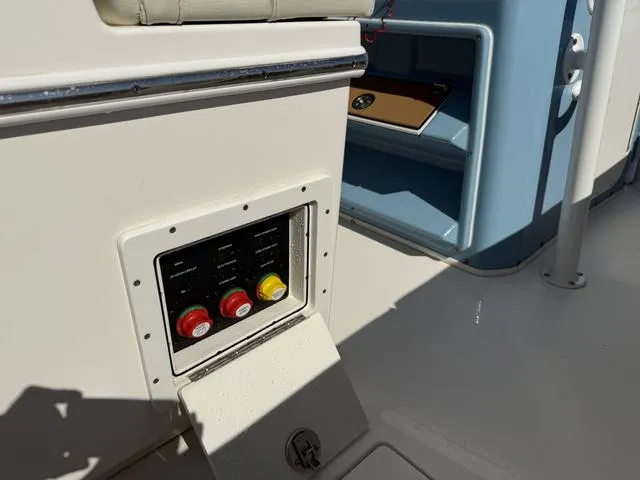 Slide: The Image of 2023 Pathfinder 2700 Open boat interior with control panel and storage compartment. - 39