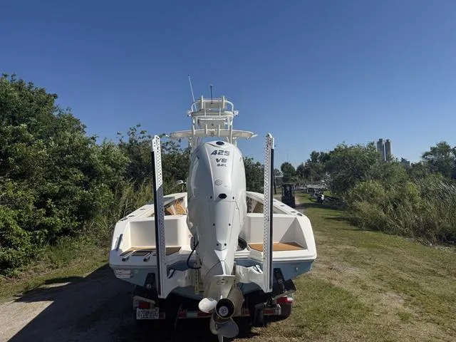 Slide: The Image of 2023 Pathfinder 2700 Open boat with Yamaha 425 V8 engine, parked on a grassy path. - 4