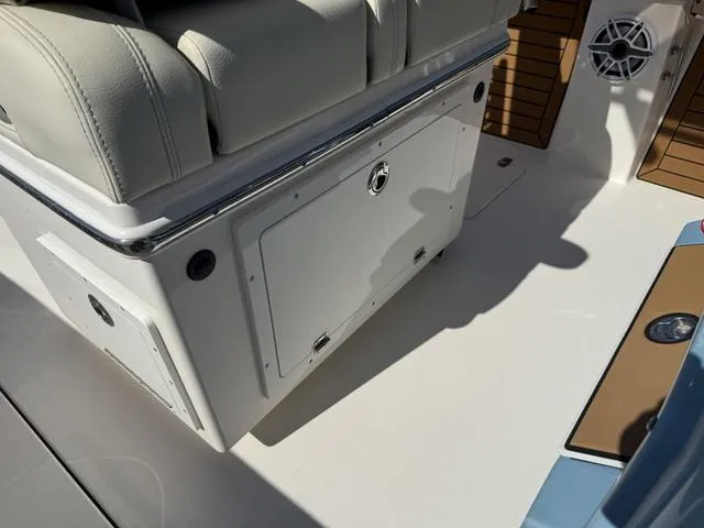 Slide: The Image of 2023 Pathfinder 2700 Open boat interior with cushioned seating and storage compartment. - 42