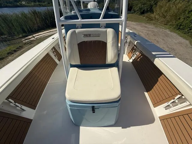 Slide: The Image of 2023 Pathfinder 2700 Open boat interior with cushioned seating and wood accents. - 46
