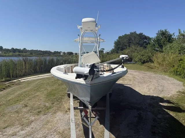 Slide: The Image of 2023 Pathfinder 2700 Open boat on trailer near a lake, surrounded by greenery. - 7