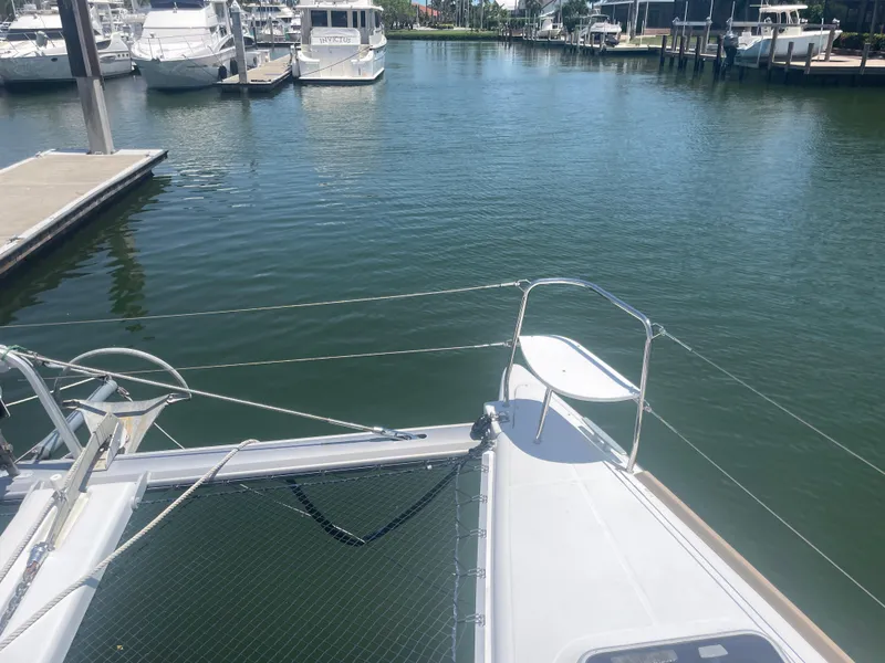 Slide: The Image of Lagoon 380 catamaran docked in a marina, 2016 model, calm water, sunny day. - 10