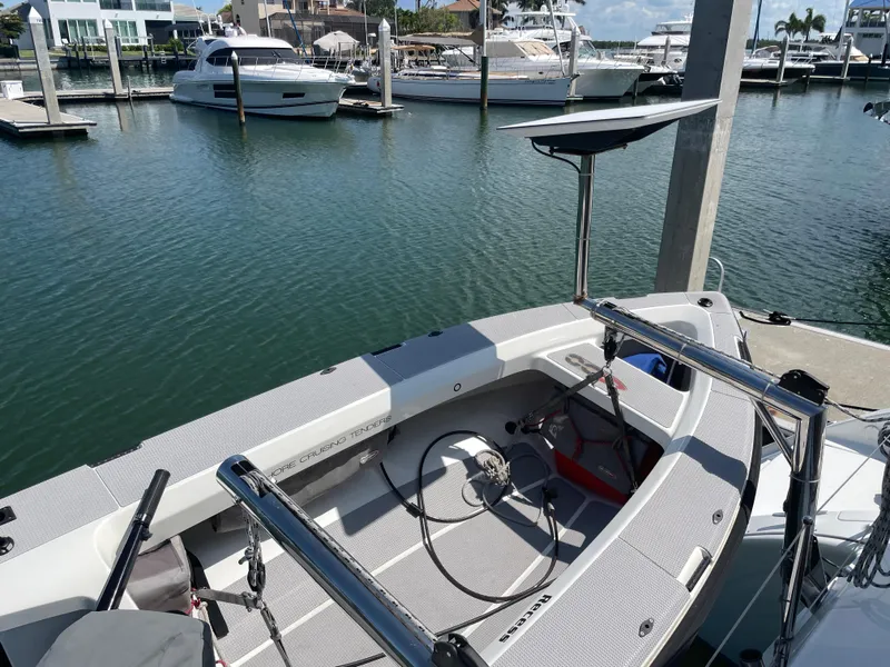 Slide: The Image of 2016 Lagoon 380 catamaran docked at marina, showcasing helm and seating area. - 16
