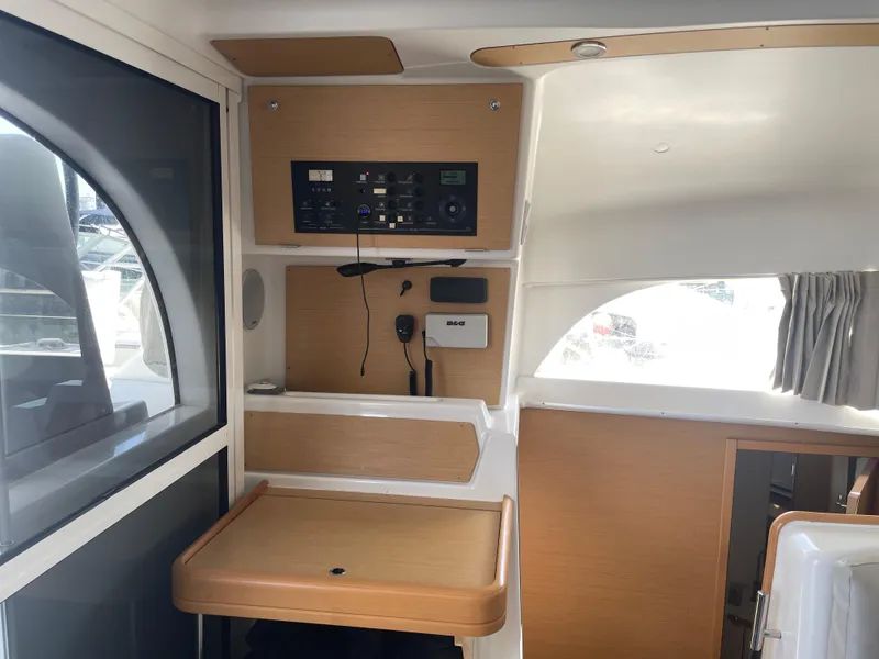 Slide: The Image of Interior of 2016 Lagoon 380 catamaran with navigation equipment and wooden accents. - 18