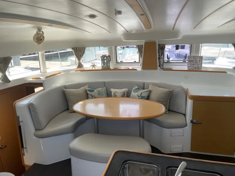 Slide: The Image of Interior of 2016 Lagoon 380 catamaran with cozy seating and round table. - 19