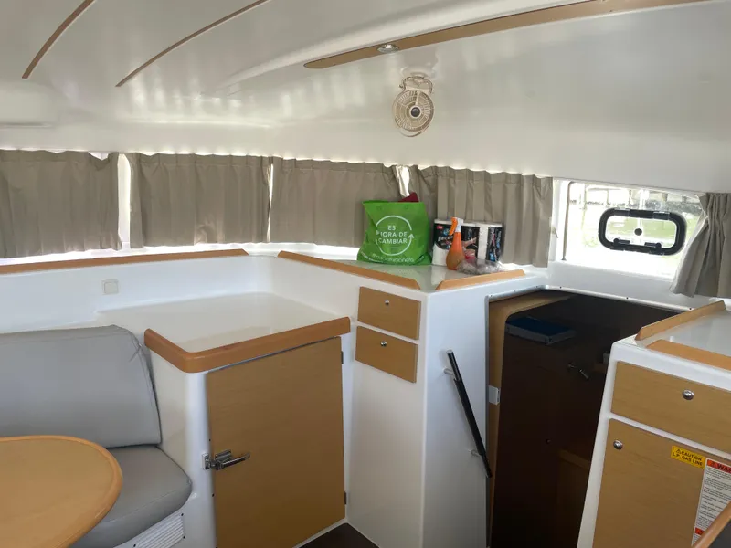 Slide: The Image of Interior of 2016 Lagoon 380 catamaran with seating, storage, and natural light. - 21