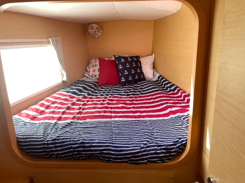 Slide: The Image of Cozy cabin bed in 2016 Lagoon 380 catamaran with nautical-themed bedding. - 24