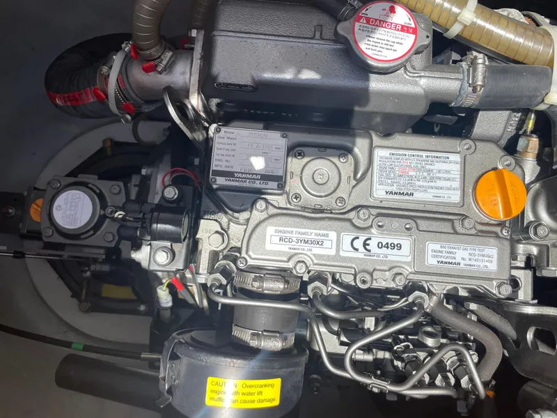 Slide: The Image of Engine of a 2016 Lagoon 380 catamaran, showcasing detailed mechanical components. - 26