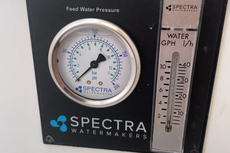 Slide: The Image of Spectra Watermakers gauge showing feed water pressure and flow rate on Lagoon 380, 2016 model. - 27