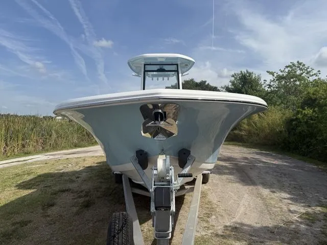 Slide: The Image of 2024 Tidewater 256 CC Adventure boat on trailer, front view, outdoors. - 11