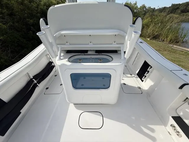 Slide: The Image of 2024 Tidewater 256 CC Adventure boat interior with fishing rod holders and storage compartments. - 15