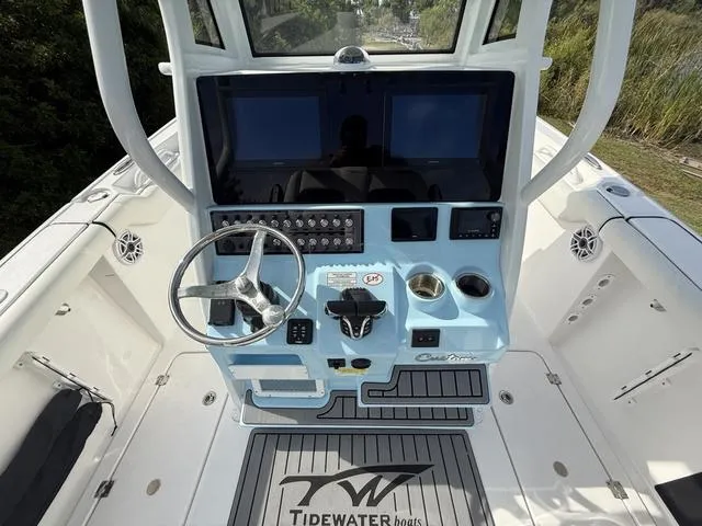 Slide: The Image of 2024 Tidewater 256 CC Adventure boat console with steering wheel and control panel. - 17