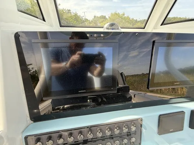 Slide: The Image of 2024 Tidewater 256 CC Adventure dashboard with dual Garmin displays and control panel. - 18