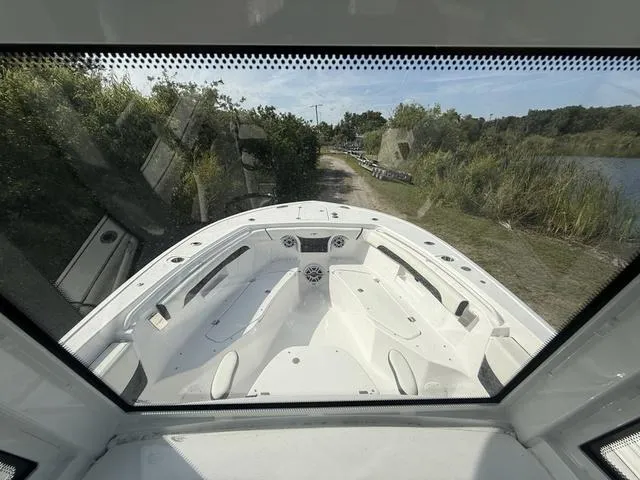 Slide: The Image of 2024 Tidewater 256 CC Adventure boat interior, viewed from the helm, showcasing seating and dashboard. - 25