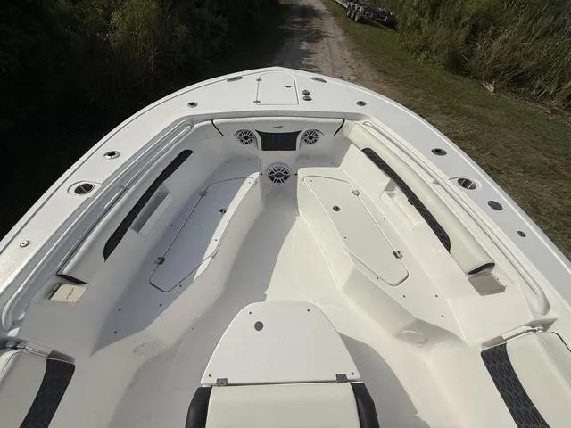Slide: The Image of 2024 Tidewater 256 CC Adventure boat interior with seating and storage compartments. - 26