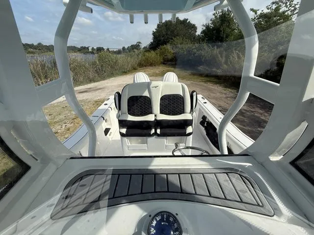 Slide: The Image of 2024 Tidewater 256 CC Adventure boat interior with dual seats and console view. - 31