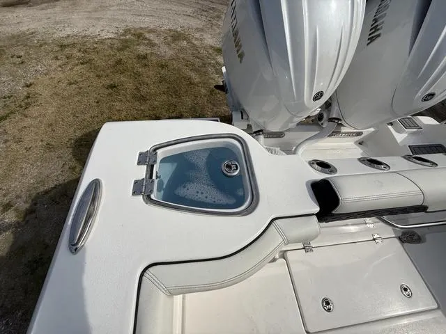 Slide: The Image of 2024 Tidewater 256 CC Adventure boat with dual Yamaha engines and livewell. - 35