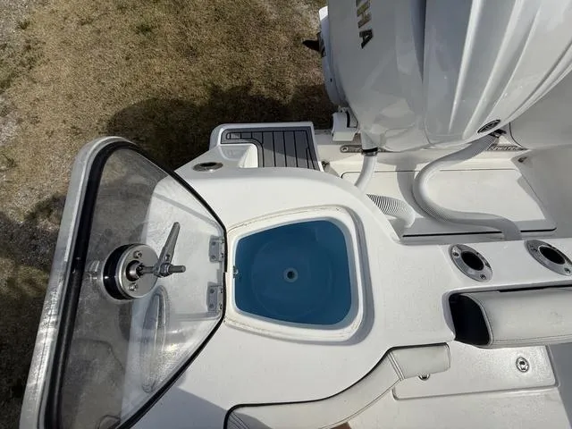 Slide: The Image of 2024 Tidewater 256 CC Adventure boat deck with Yamaha engine and fishing amenities. - 36