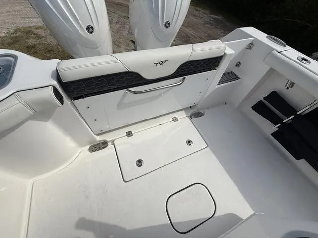 Slide: The Image of 2024 Tidewater 256 CC Adventure boat interior with seating and storage compartments. - 37