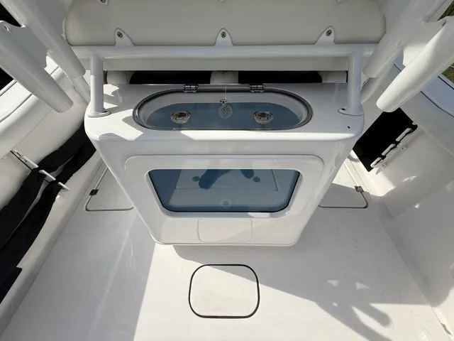 Slide: The Image of 2024 Tidewater 256 CC Adventure boat interior with a built-in sink and storage compartment. - 39