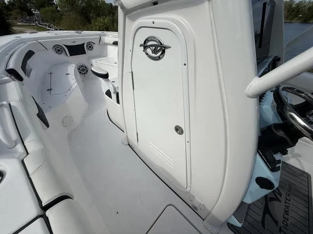 Slide: The Image of 2024 Tidewater 256 CC Adventure boat interior with seating and storage compartment. - 41