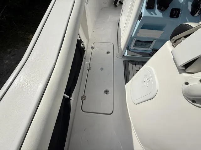 Slide: The Image of 2024 Tidewater 256 CC Adventure boat interior, featuring storage compartment and seating area. - 43