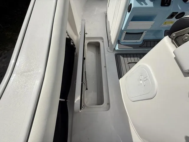 Slide: The Image of 2024 Tidewater 256 CC Adventure boat interior with open storage compartment. - 44