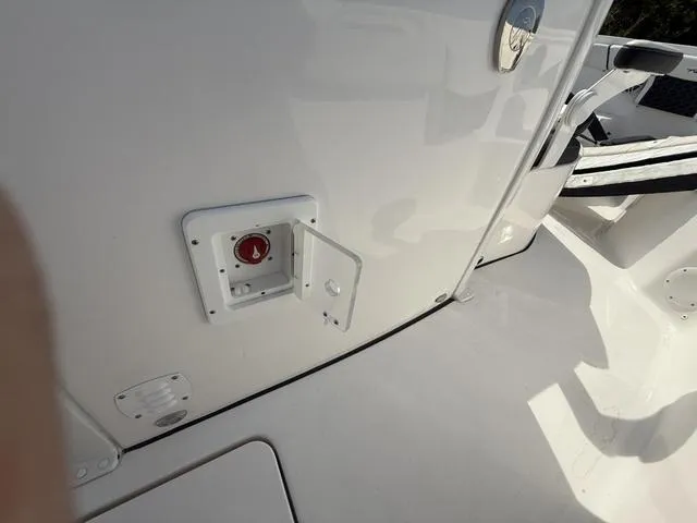 Slide: The Image of 2024 Tidewater 256 CC Adventure boat deck with access panel and seating area. - 47