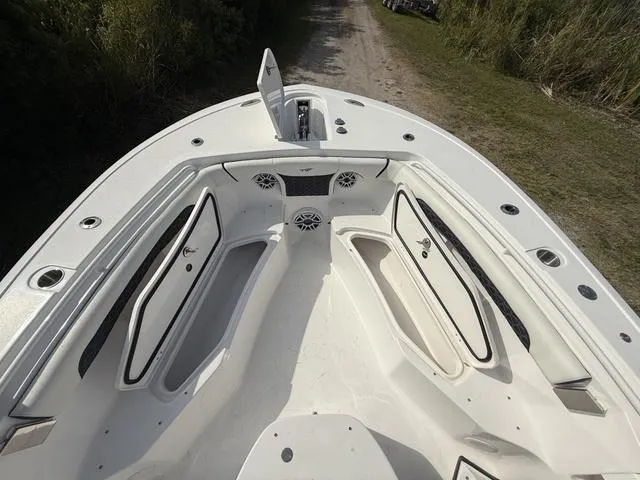 Slide: The Image of 2024 Tidewater 256 CC Adventure boat deck with storage compartments and speakers. - 48